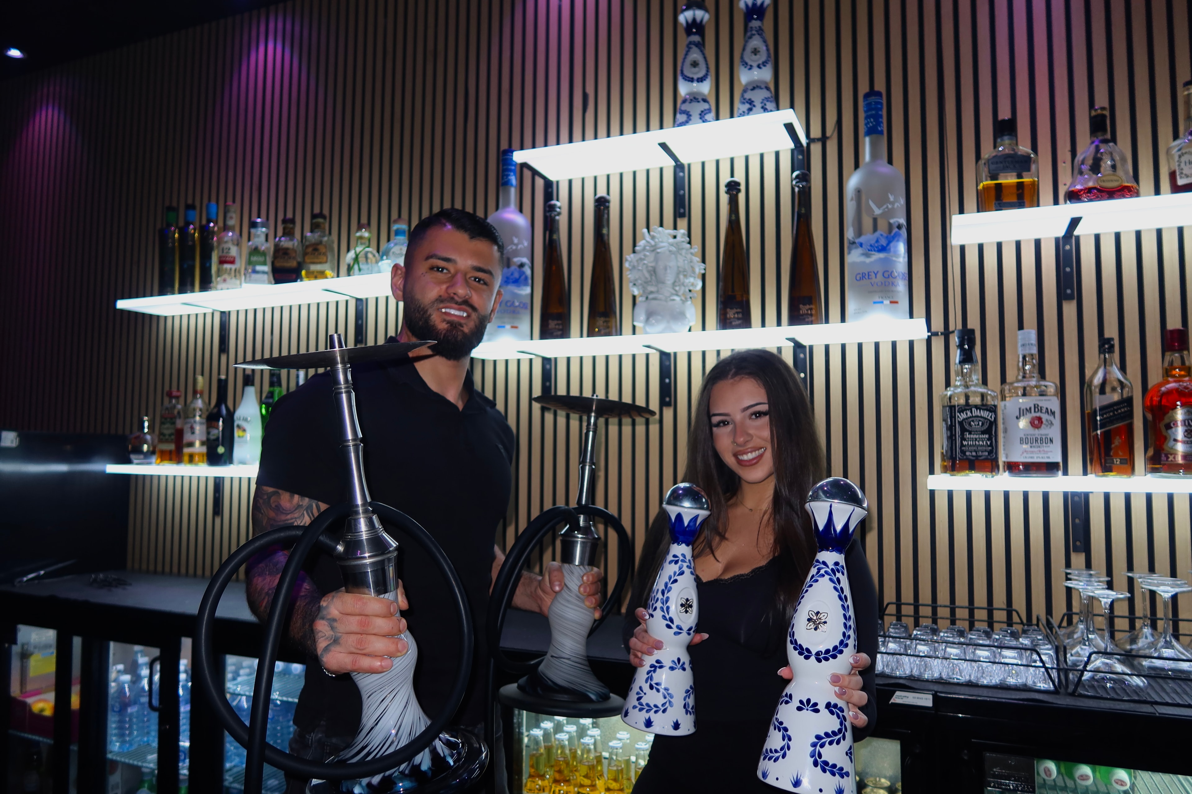 Medusa Lounge team members with hookahs at the bar
